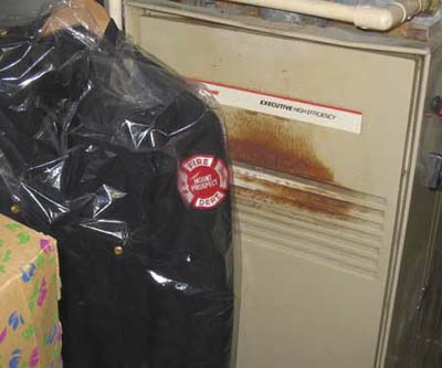 Firefighter uniform hanging in home with fire safety irony.