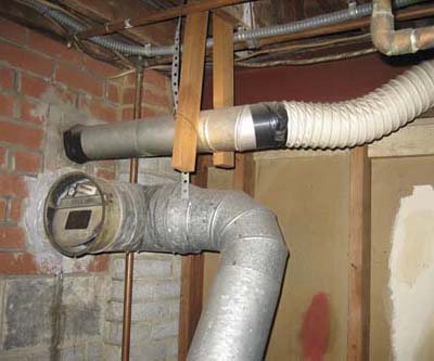Clothes dryer venting directly into chimney above oil boiler exhaust.
