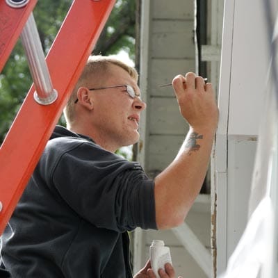 Touching up holes and imperfections in siding.