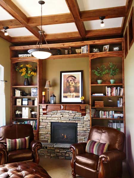 A living room with exposed beams and built-in bookcases