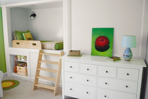 A bedroom with a small bed in a built-in storage area