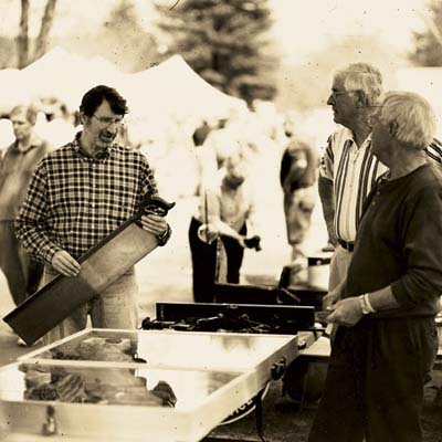 Norm Abram holds and discusses a vintage tool with a couple hoping to sell it.