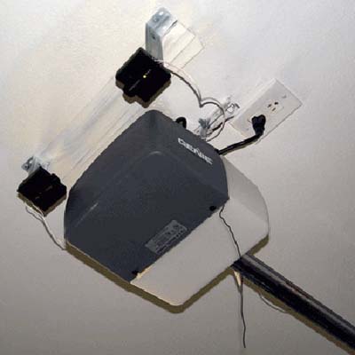 Garage door infrared sensors mounted uselessly high on ceiling.