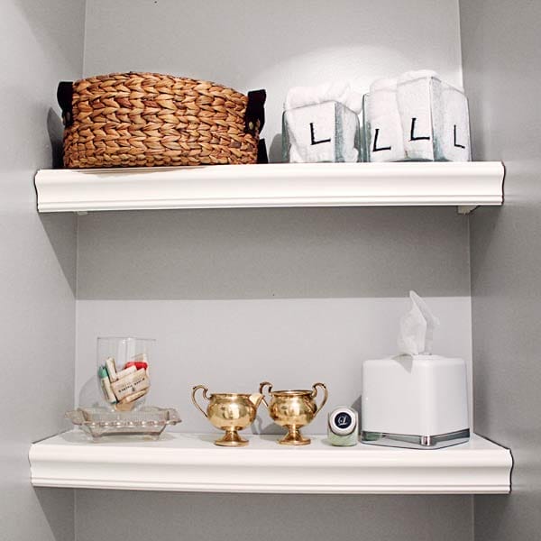 Open shelving with a storage basket and decor in a bathroom