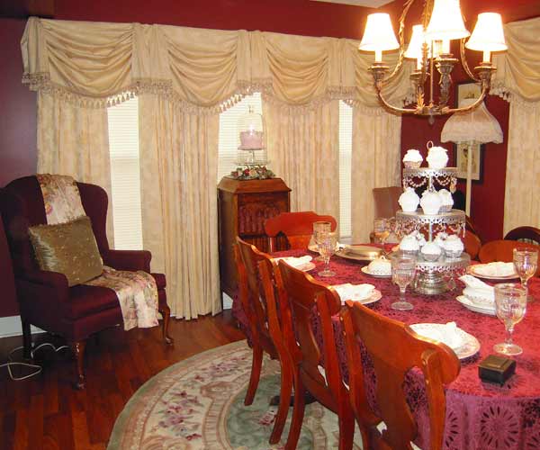 A decorated dining room with large curtains