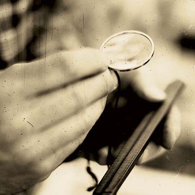 A person holds an antique measuring instrument