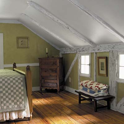 A master bedroom with a sloped ceiling