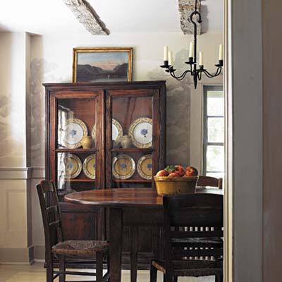 A dining room with a table and china closet