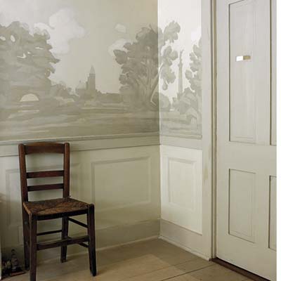 Walls with ornate wallpaper and wainscoting