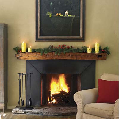 A mantel with garland and candles