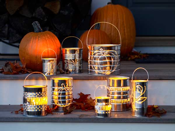 Tin cans with designs punched into them and lights