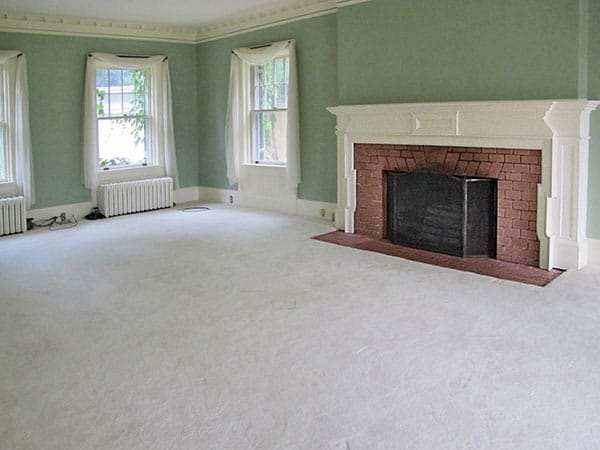 A living room with fireplace and green walls