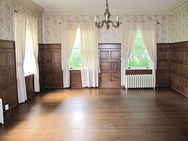 An empty interior room with original woodwork