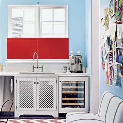 A kitchen area with a roller shade