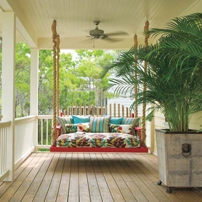 A hanging daybed on a porch