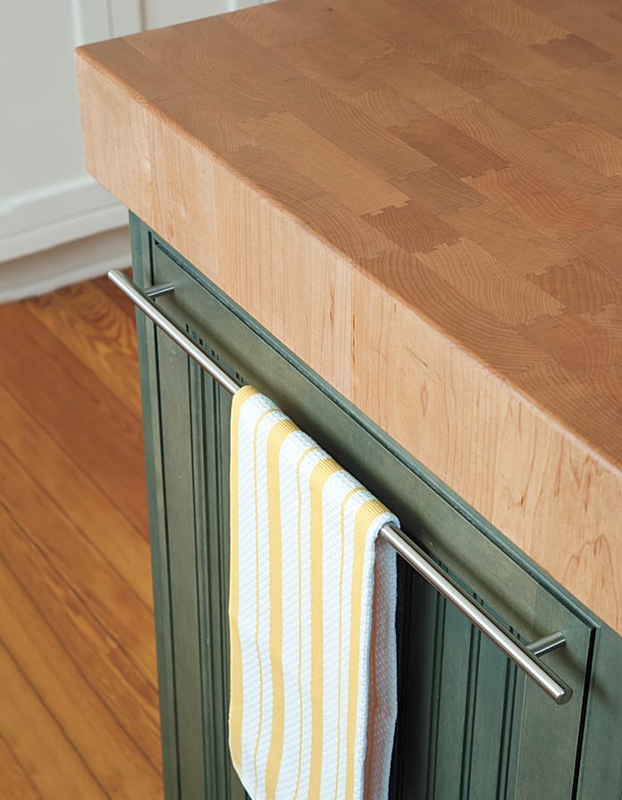 a new kitchen island with a wood cutting board top