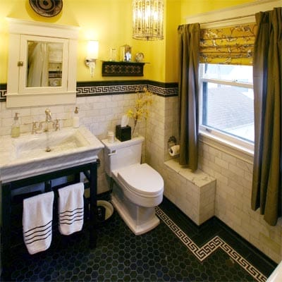 Chartreuse bathroom walls and window blinds with Greek-key tile border design.