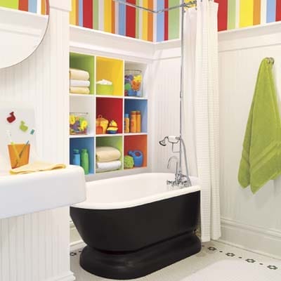 Children's bathroom with colorful striped wallpaper.