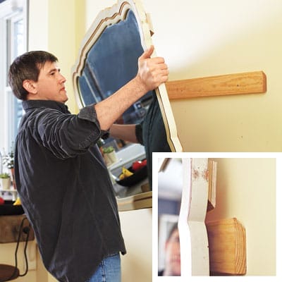Man hanging mirror