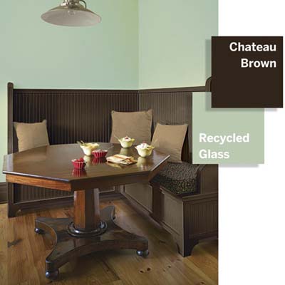 Breakfast nook with mint green walls and chocolate brown built-in bench.