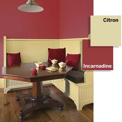 Breakfast nook with crimson red walls and custard-colored built-in bench.