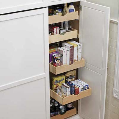 a pull out pantry from a cabinet for organization and storage of food and cooking items
