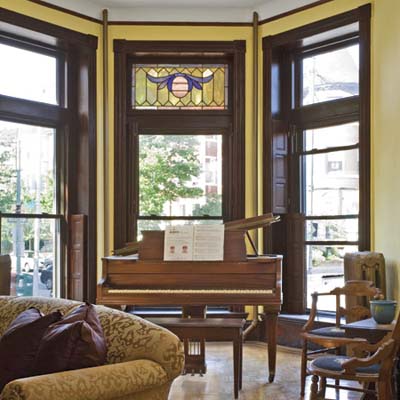 A front room with woodworking details and a piano