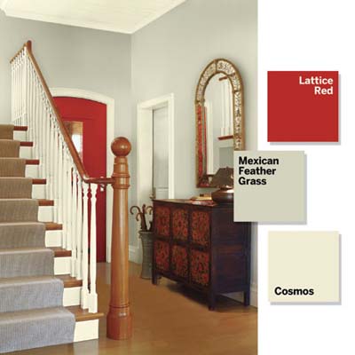 Entry foyer with taupe walls, red door, and light-colored trim and ceiling.