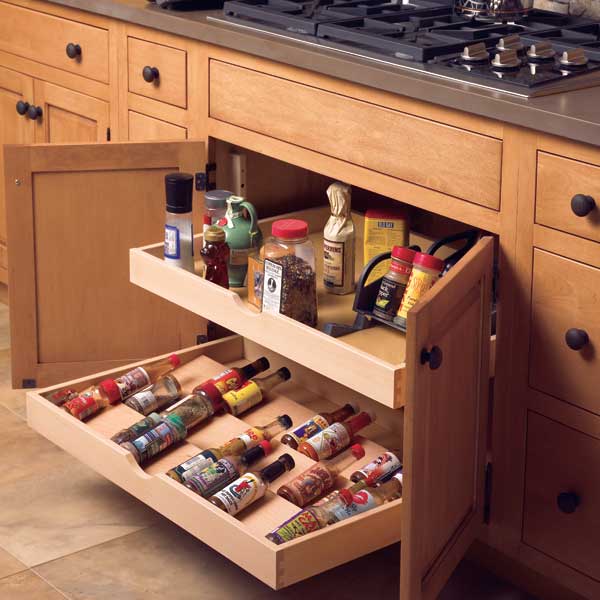 storage drawers within a kitchen cabinet for spices and sauces