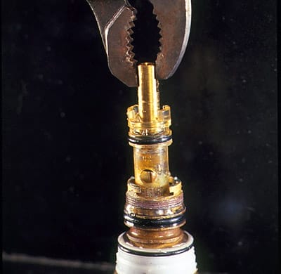 The old faucet cartridge is removed.