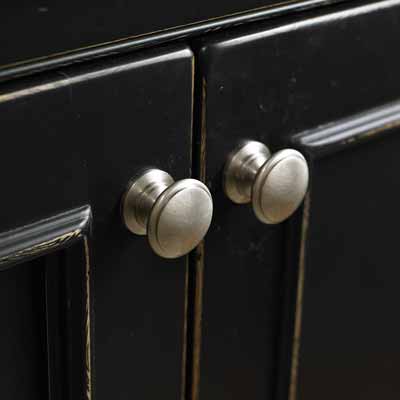 Close-up on cabinet door pulls.