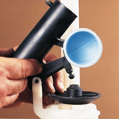 The old toilet flapper valve is removed
