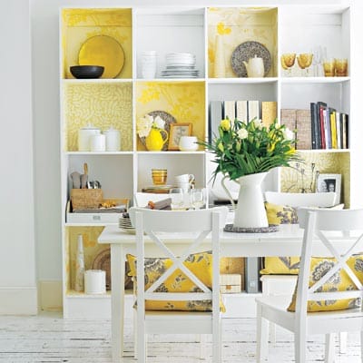 Storage cubbies with yellow wallpaper