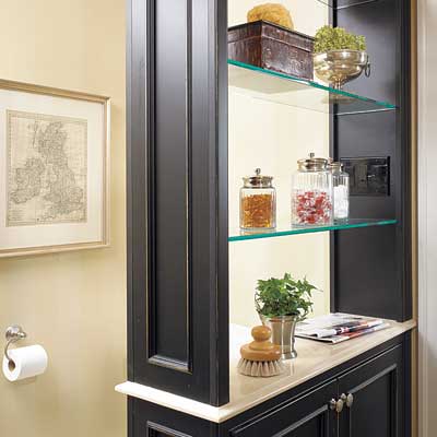 A black partition in the bathroom with open shelving.