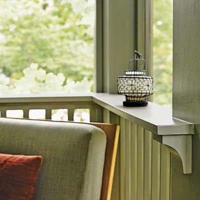 Thick rail ledge holding a decorative lantern.