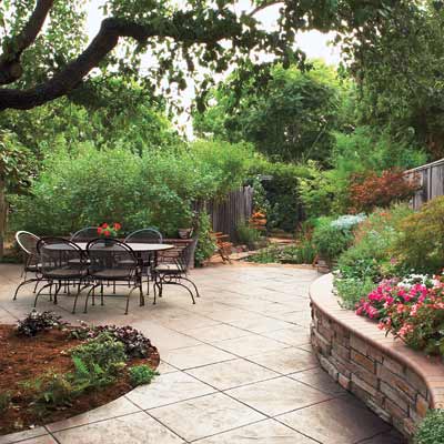 Stone outdoor patio with a large dining table.
