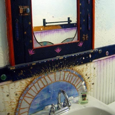 Bathroom before renovation showing psychedelic-themed medicine cabinet.