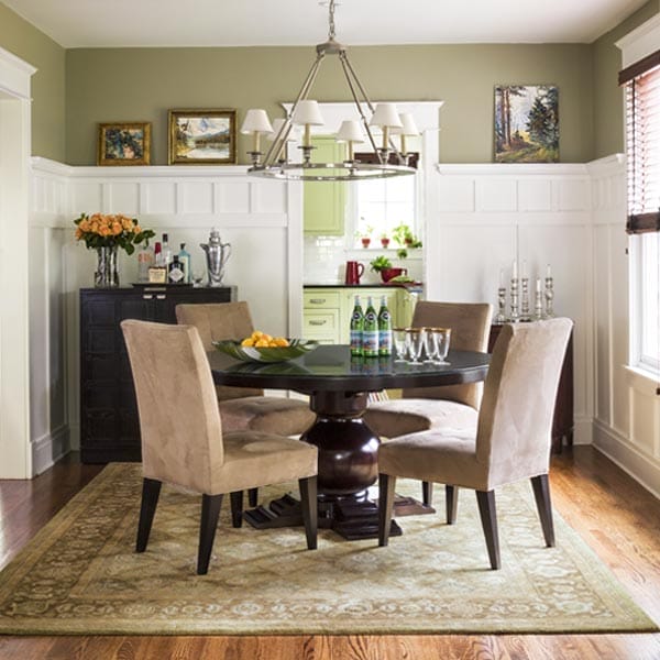 A dining room with a table and chairs
