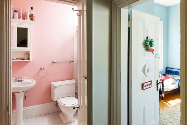 A second-floor bathroom with pink walls.