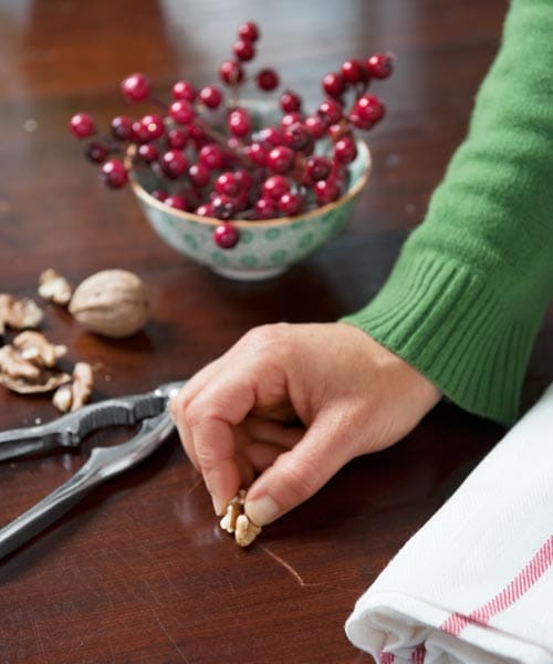Someone using a walnut to remove a scratch