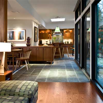 Open floor plan using different materials and ceiling heights for definition.