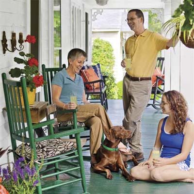 John, Kim, and Kelly Henson enjoying their front porch