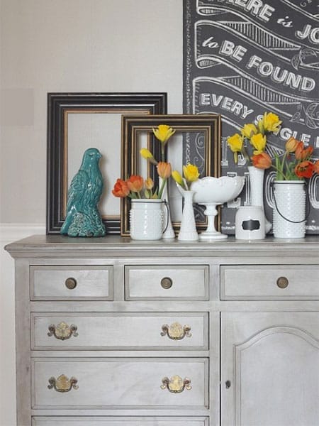 Gray buffet table holding decorations.