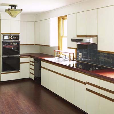 1980s kitchen with outdated cabinets and appliances needing renovation.