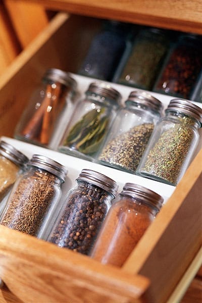 Spices organized in a kitchen drawer.