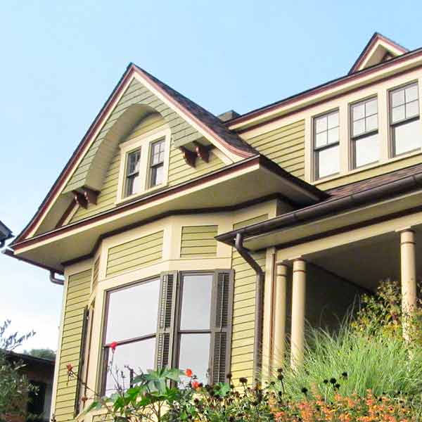 Close-up on windows and siding on the Queen Anne house.
