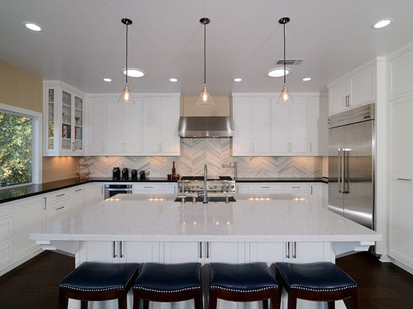 A white kitchen with layered lighting as part of a universal design.