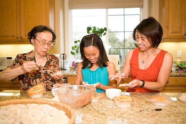 A family cooking in the kitchen together.