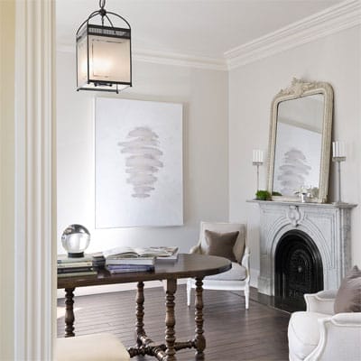 Formal front room with dark wood floors and large molding.