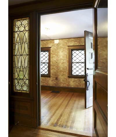 Front entryway with original door and stained-glass windows.